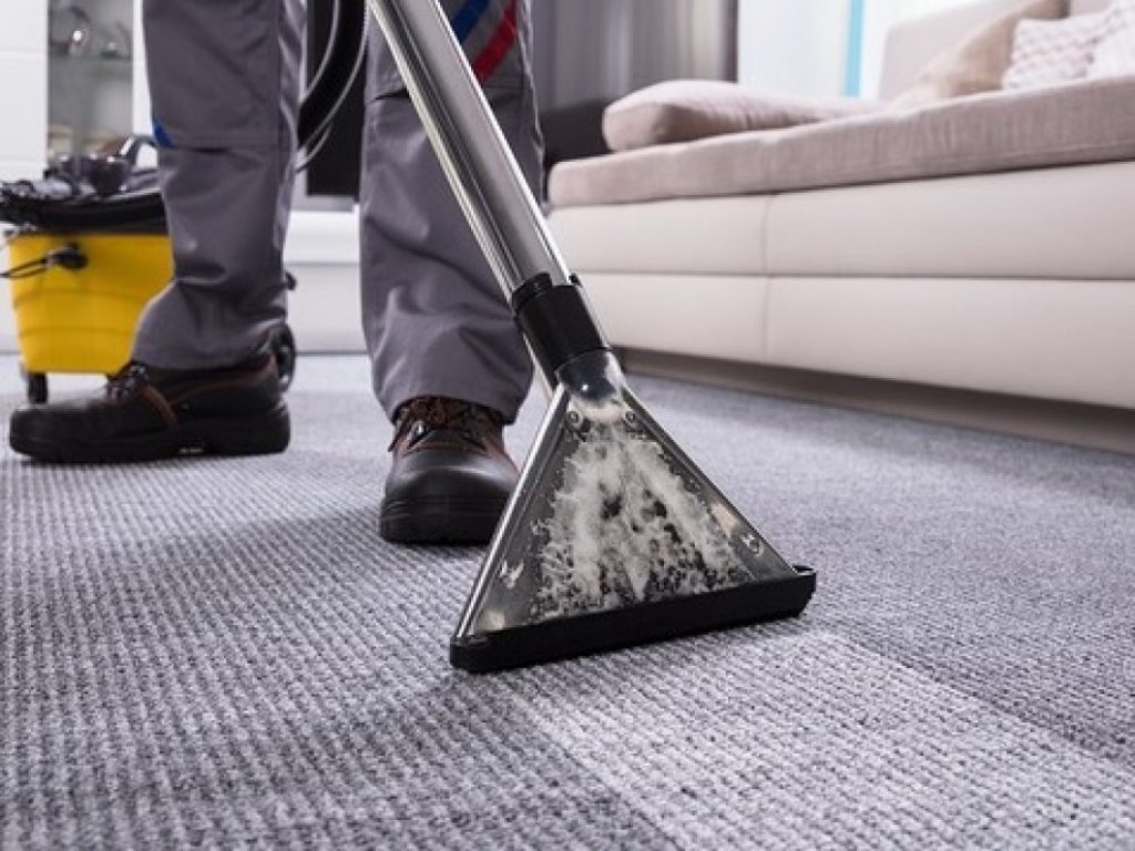 A worker doing professional carpet cleaning in Matthews, NC
